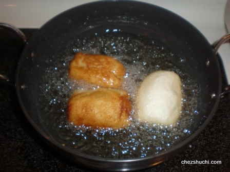 bread rolls are being deep fried