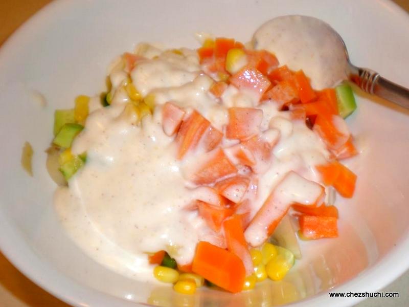 mayonnaise sauce poured onto boiled veggies